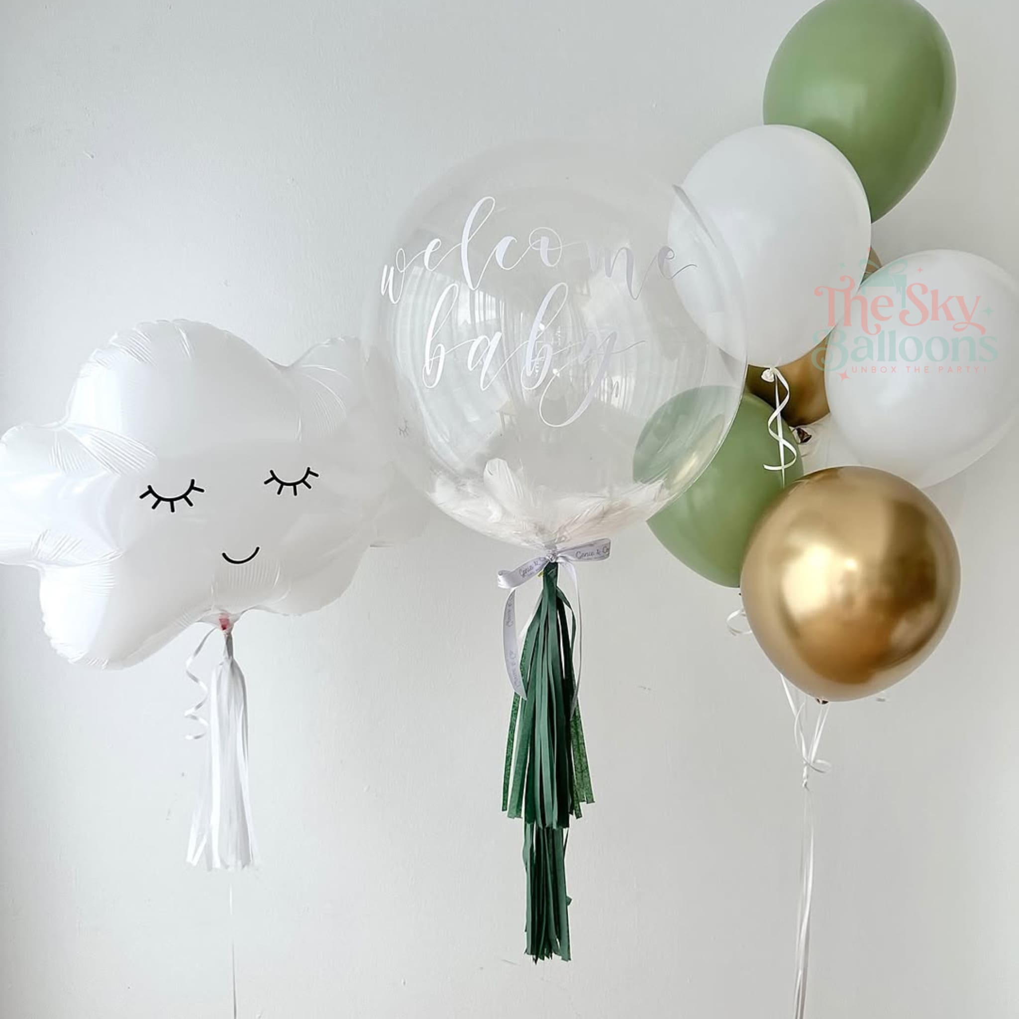 Decorative balloons including a cloud-shaped balloon, clear balloon with text, and gold and green balloons on a white background.