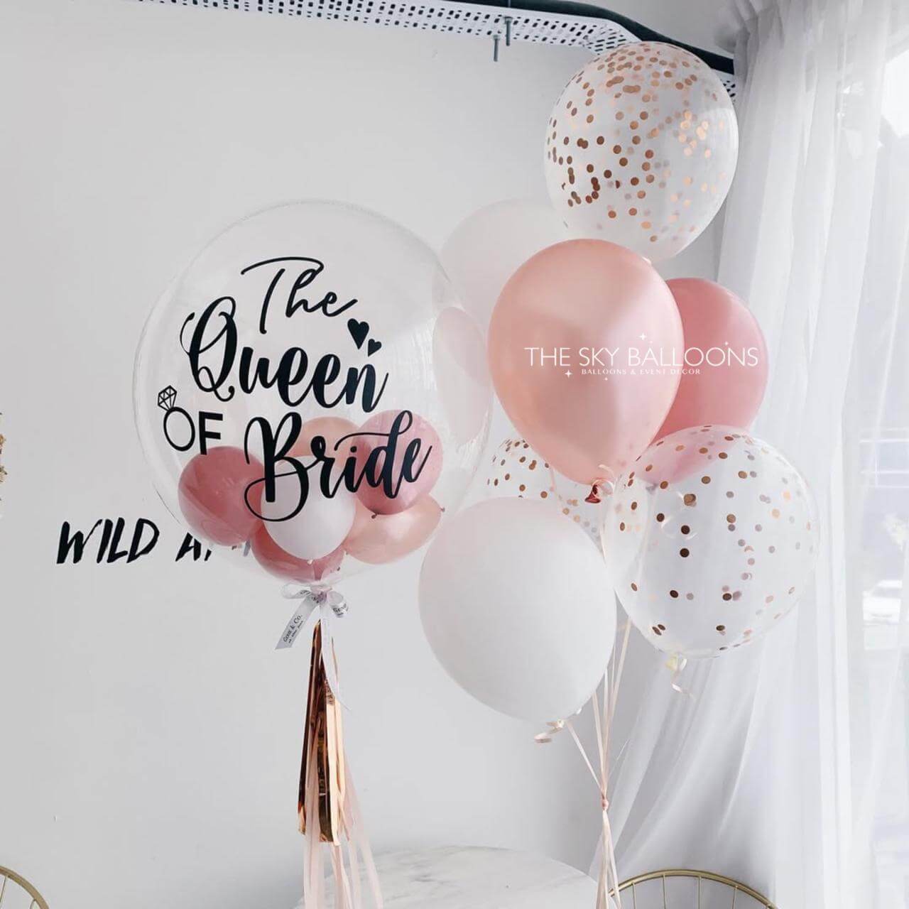 Decorative balloons with 'The Queen of Bride' text and confetti on a white background.