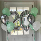 Decorative balloons with numbers '20' and colored balloons in front of a door.