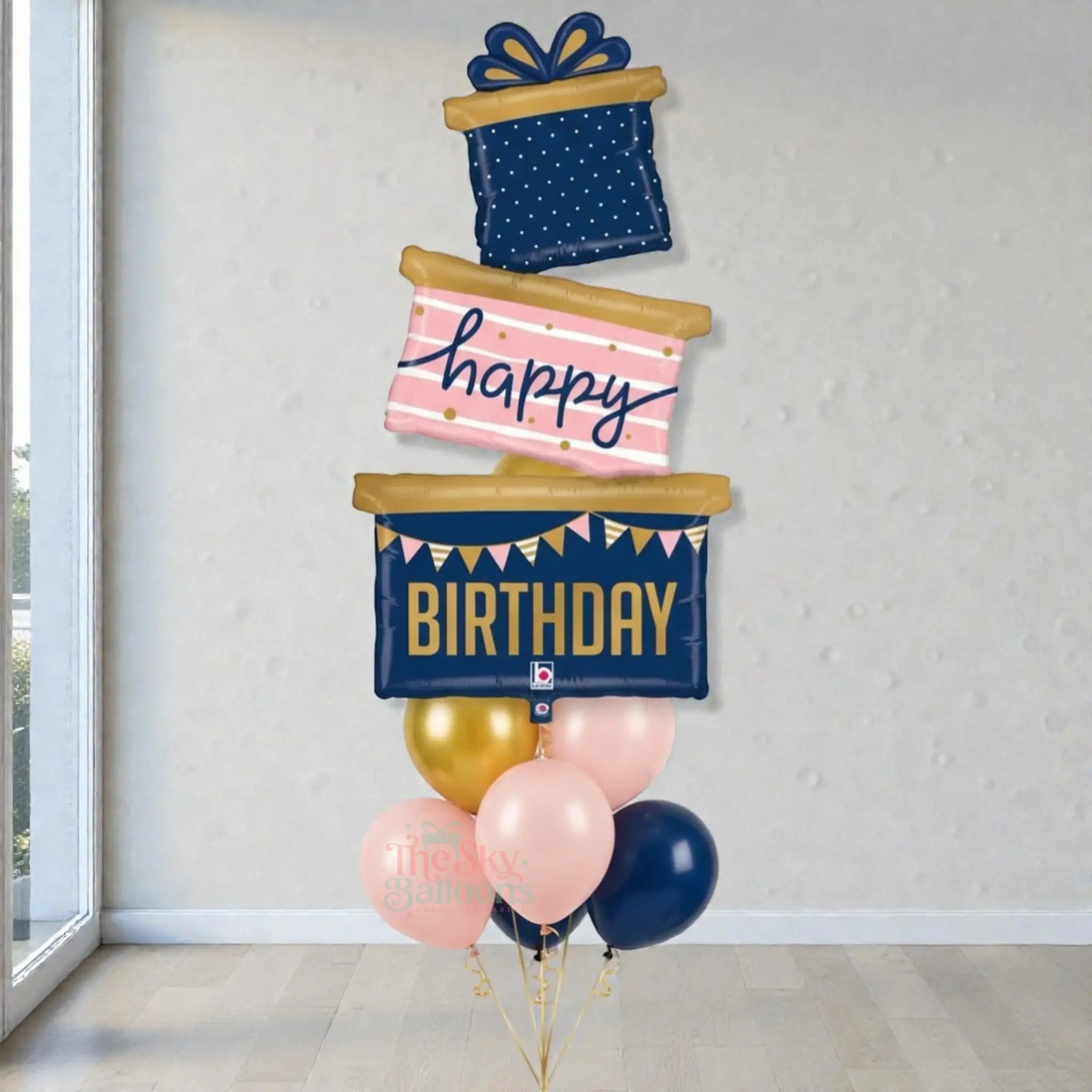 Decorative birthday balloons shaped like presents with 'Happy Birthday' text on a neutral background.