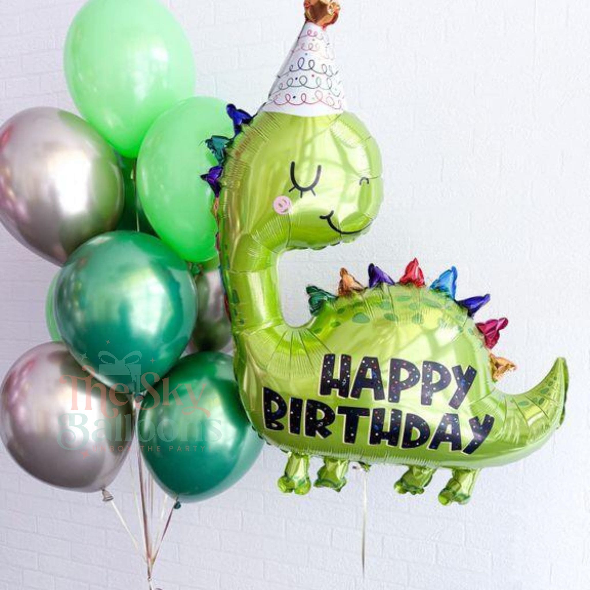 Green dinosaur-shaped balloon with 'Happy Birthday' text among other balloons on a white background