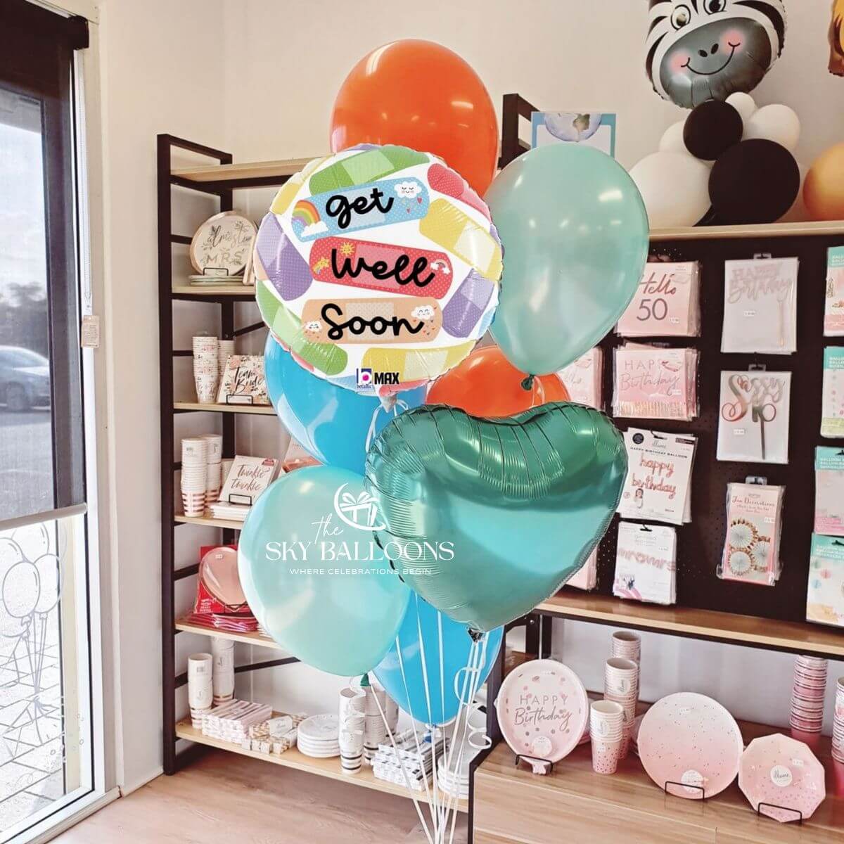 Get Well Soon balloon bouquet with a colourful message foil, teal heart foil and orange, blue and mint latex balloons.