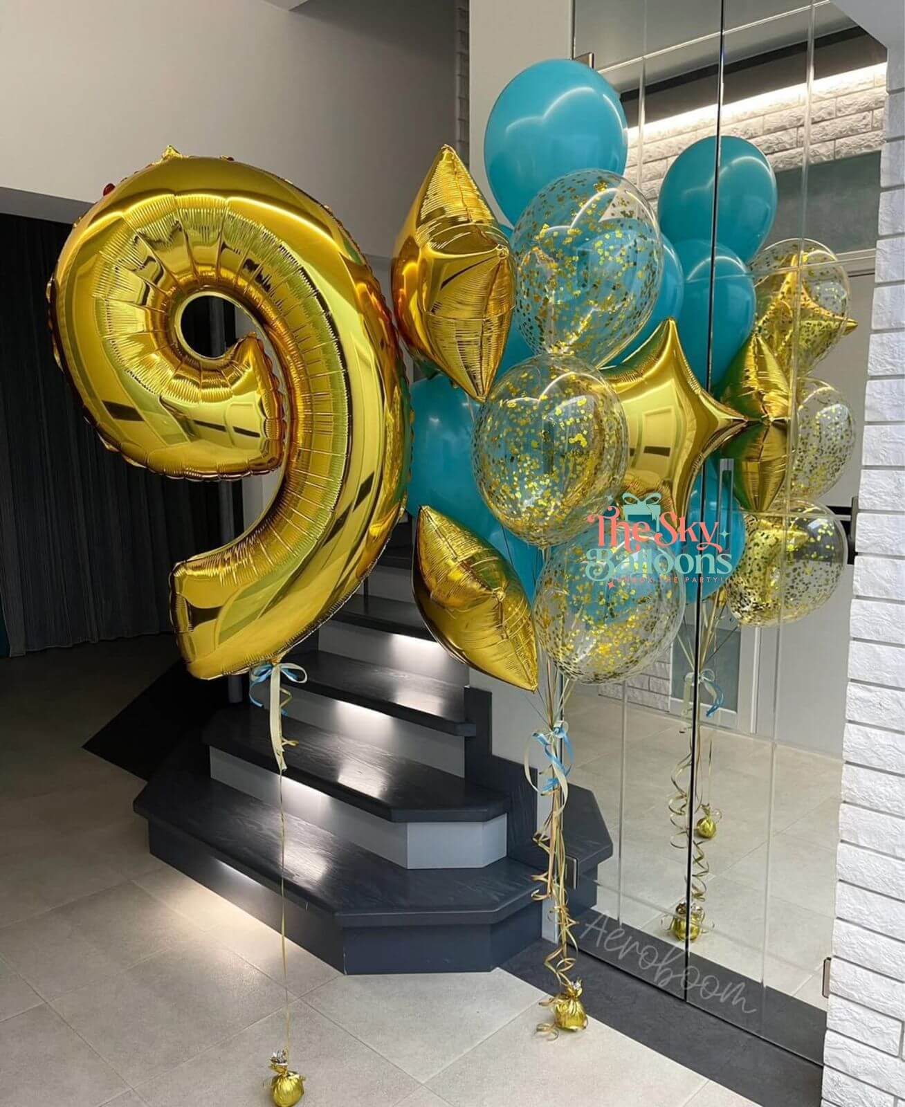 Gold and blue balloons with a number 9 on a staircase