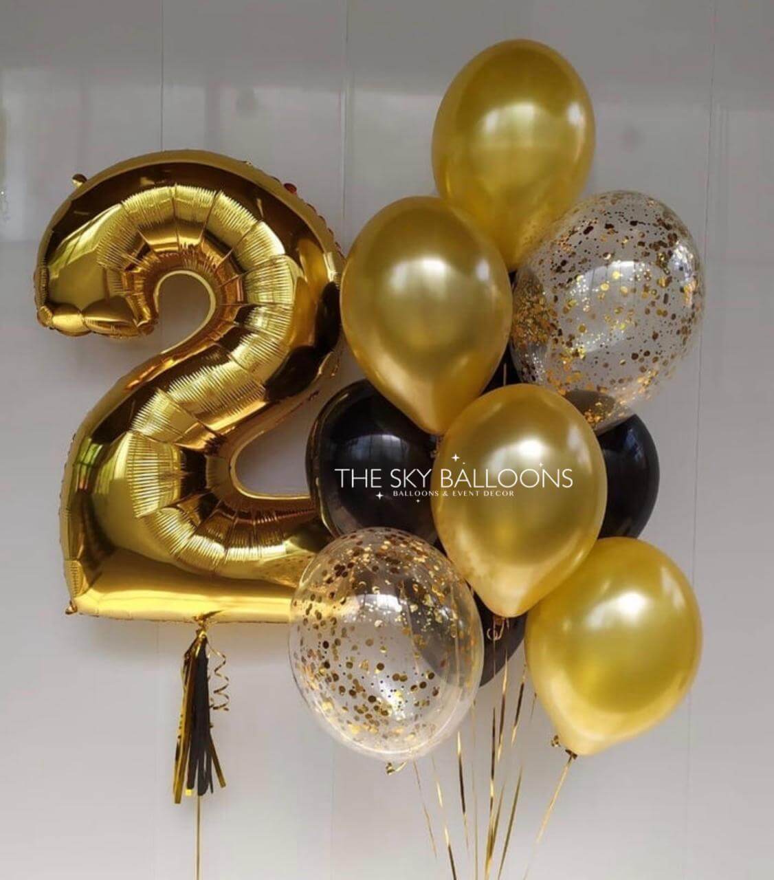 Gold and black balloons with a number '2' balloon, featuring 'The Sky Balloons' brand.