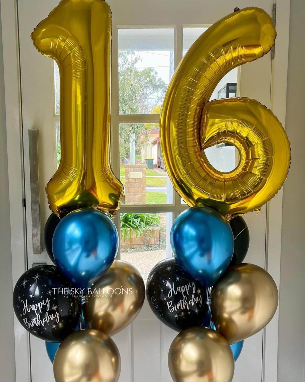 Gold, blue, and black balloons shaped like the number '16' with 'Happy Birthday' text.