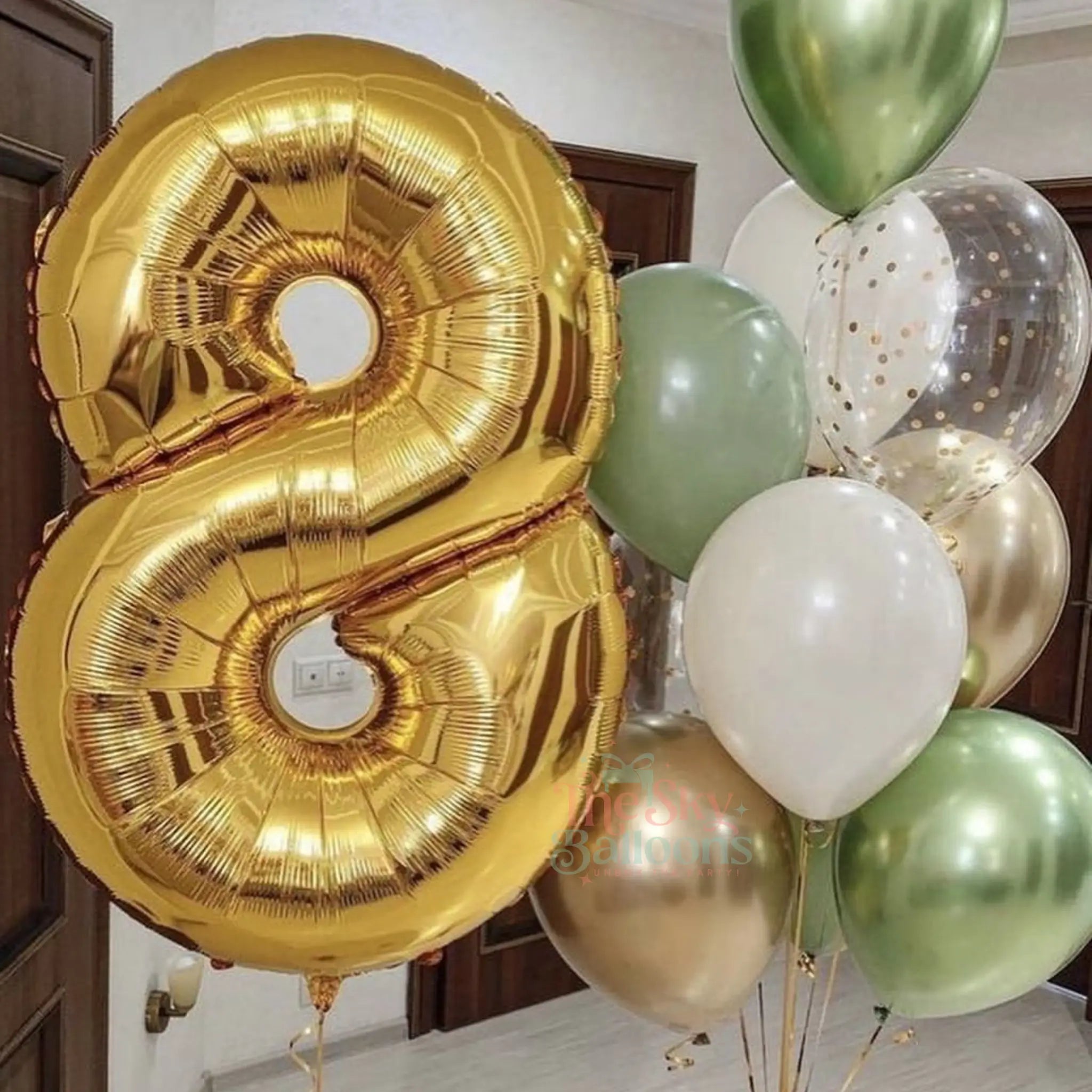 Gold number 8 balloon and other balloons in a room setting