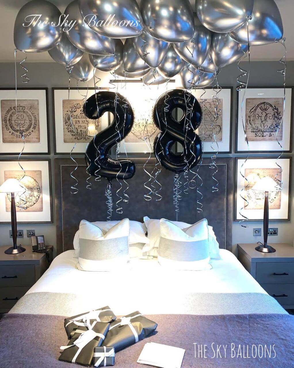 Happy 28th birthday balloon arrangement in colorful party setup