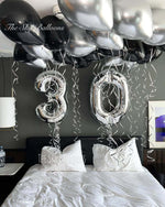 Happy 30th birthday balloon arrangement in colorful party setup