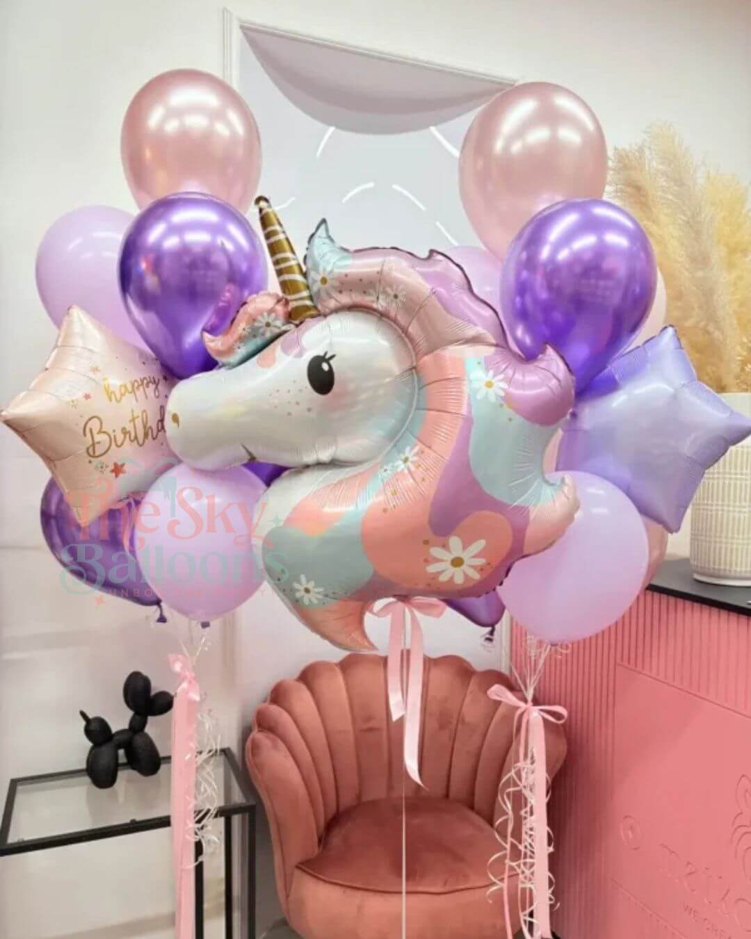 Unicorn balloon with colorful balloons in a room setting