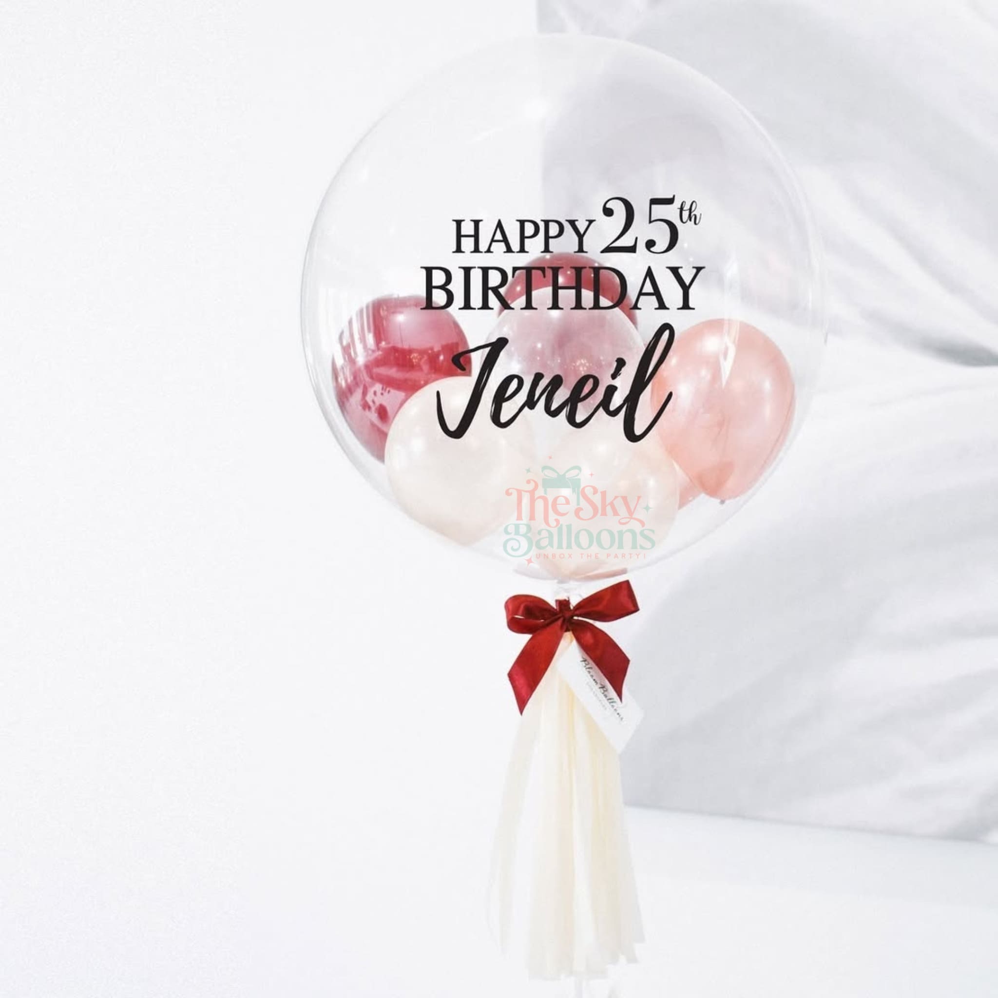 Personalized birthday balloon with pink balloons and a red bow on a white background