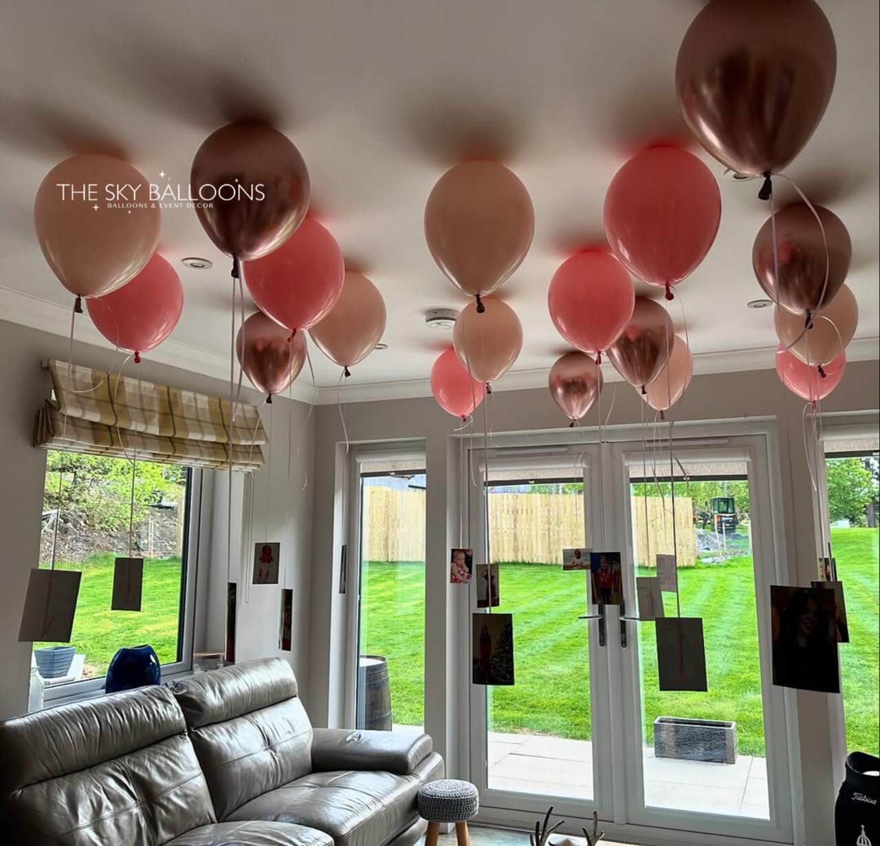 Living room with pink and gold balloons on the ceiling