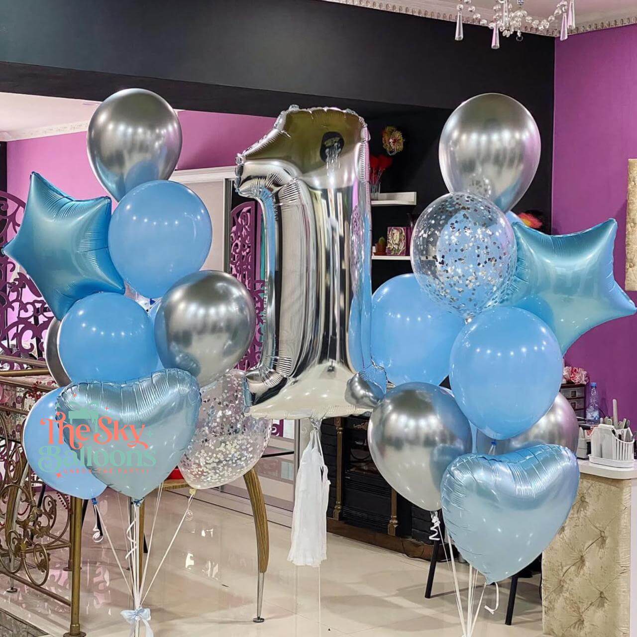 Decorative balloons with a number 40 foil balloon in a room with purple walls.