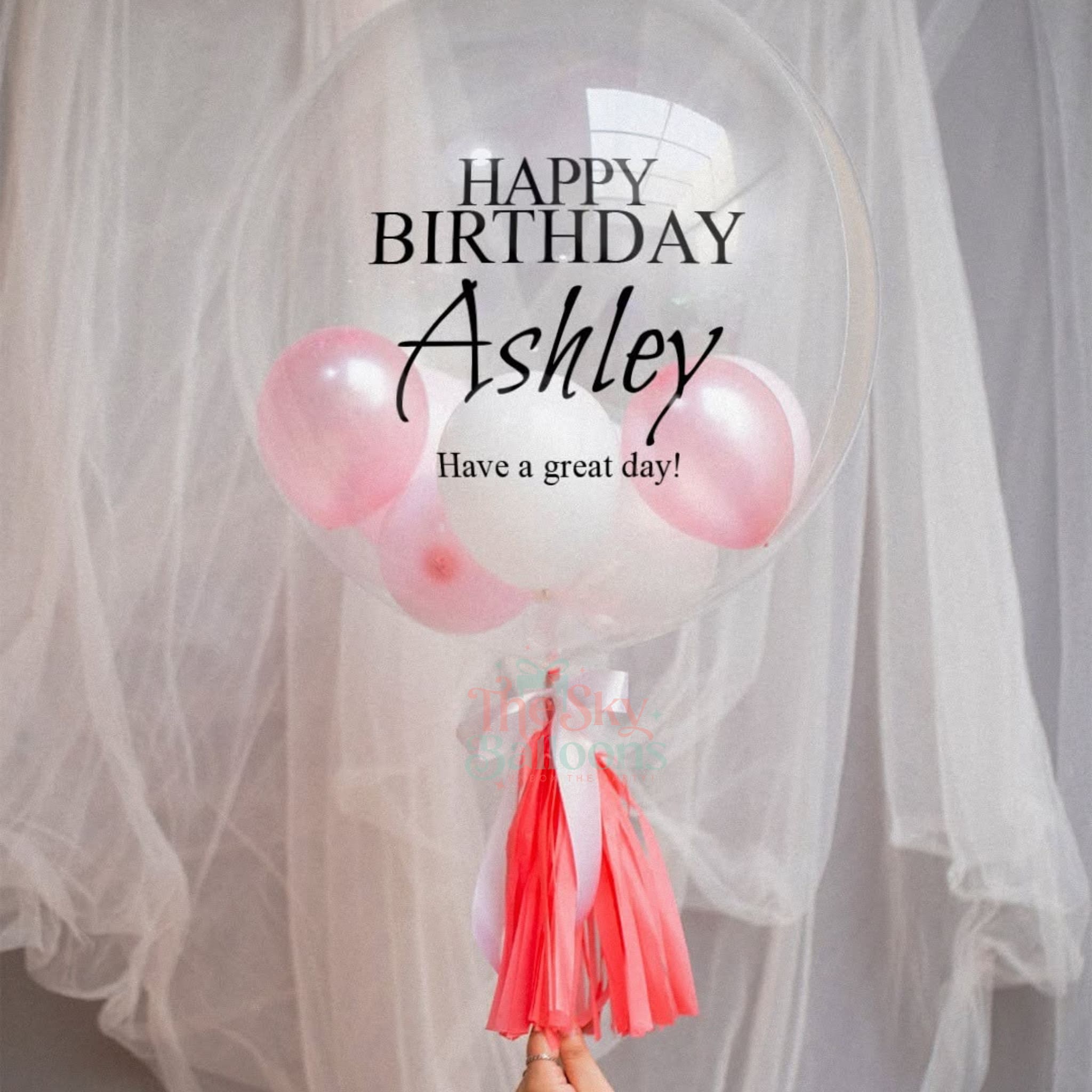 Balloon with 'Happy Birthday Ashley' text against a light background