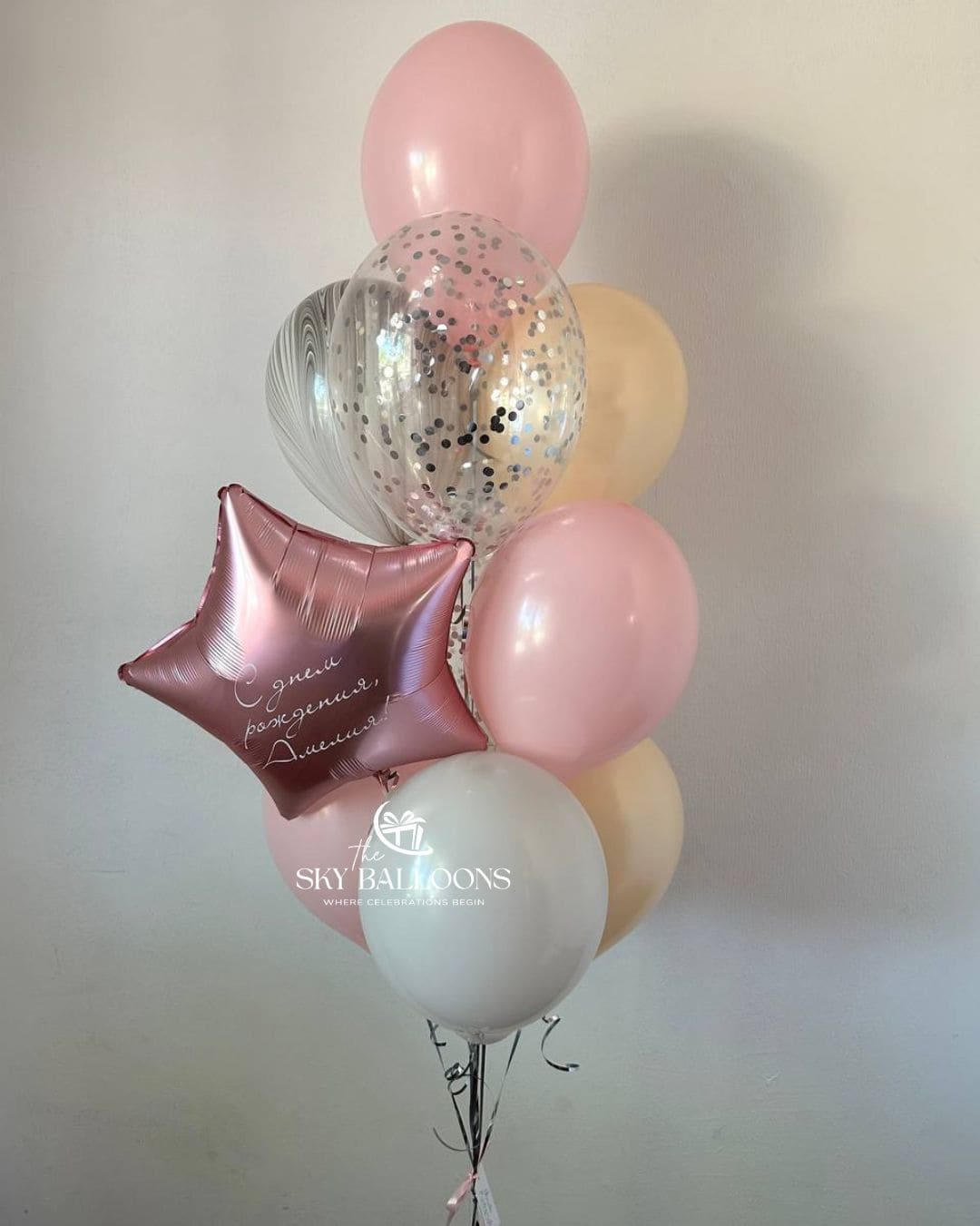 Pastel balloon bouquet with a personalised pink star foil balloon, pink, cream and white latex balloons, a silver heart and a clear confetti balloon.