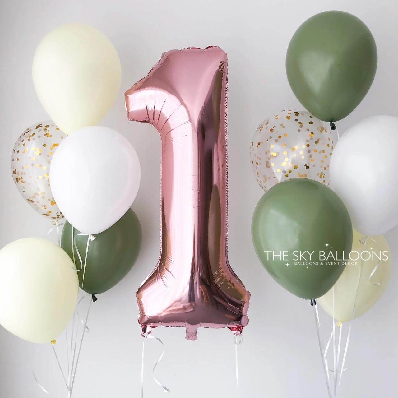 Pink number '1' balloon surrounded by other balloons on a white background