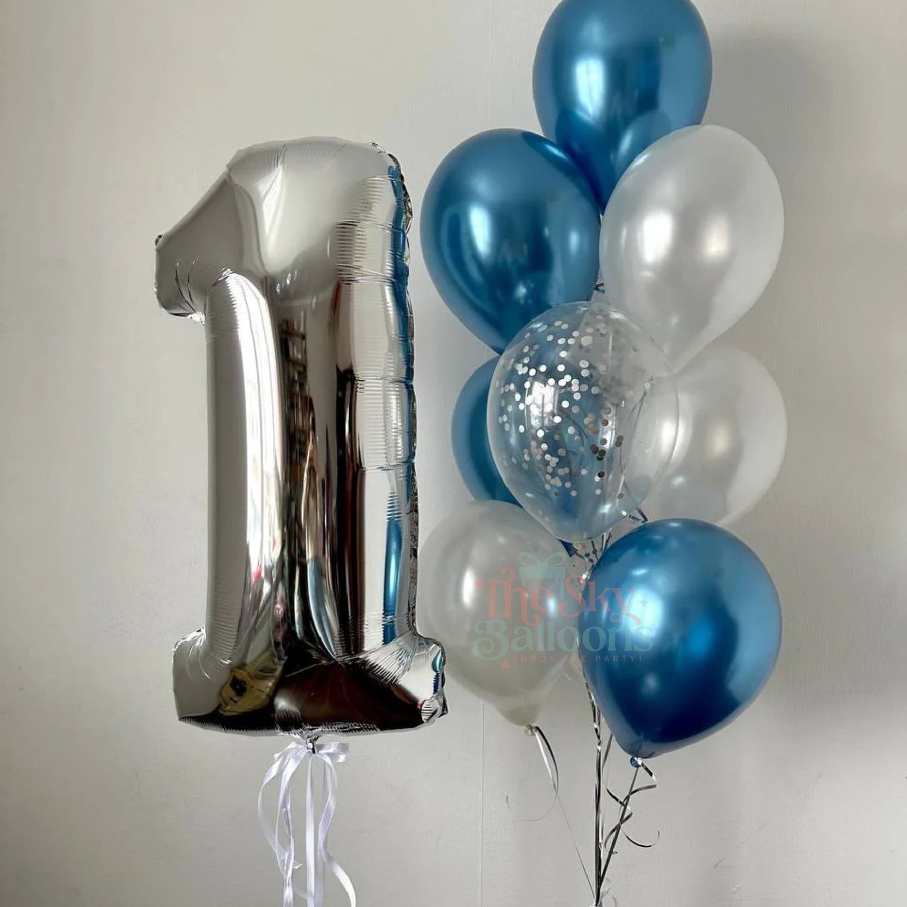 Silver number 1 balloon with blue and clear balloons on a white background