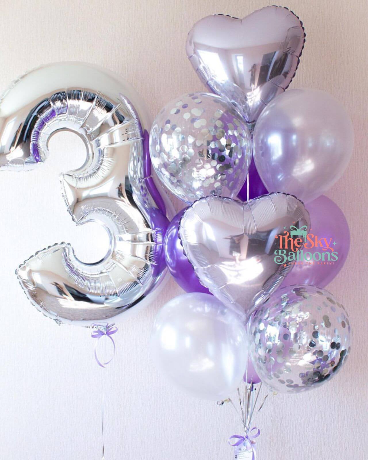 Silver balloon with number '3' and other balloons on a white background
