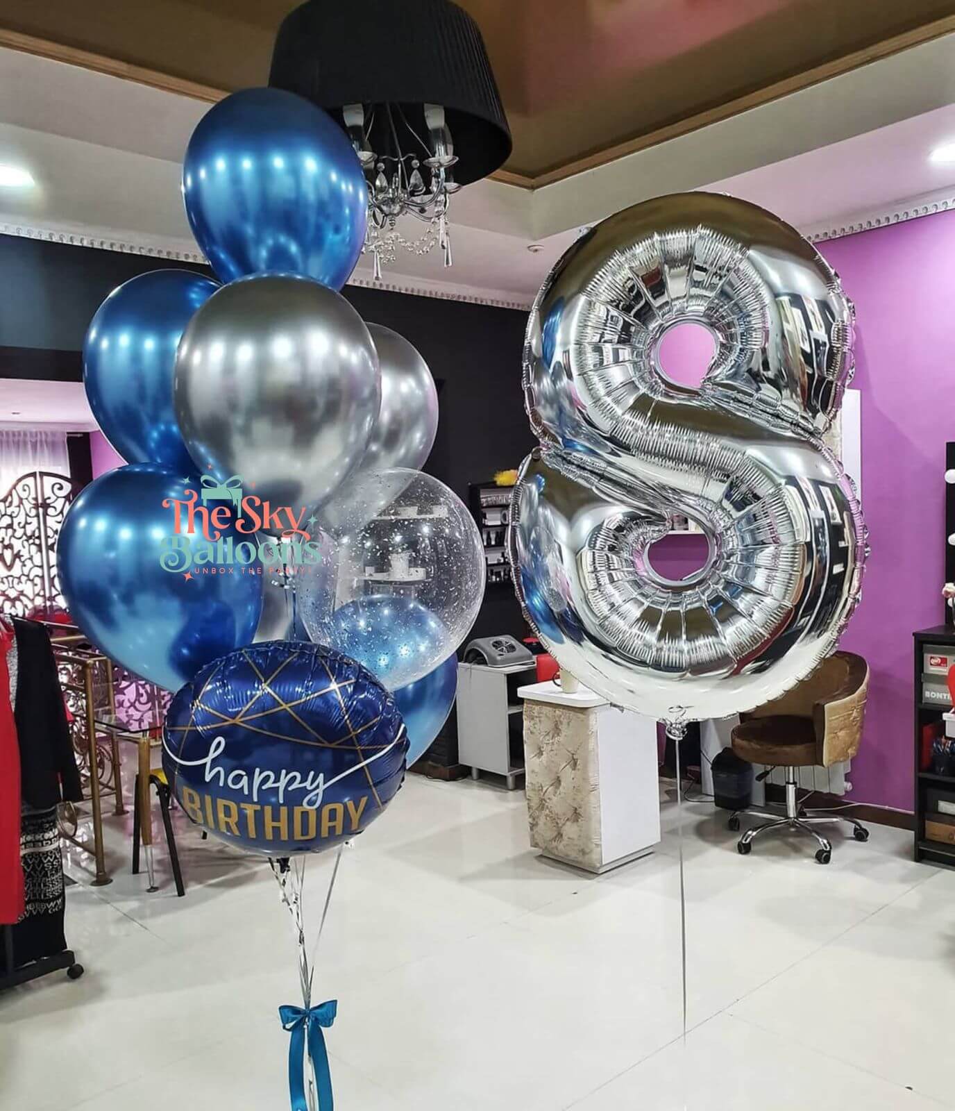 Bouquet of balloons with a large number '8' in a room setting.