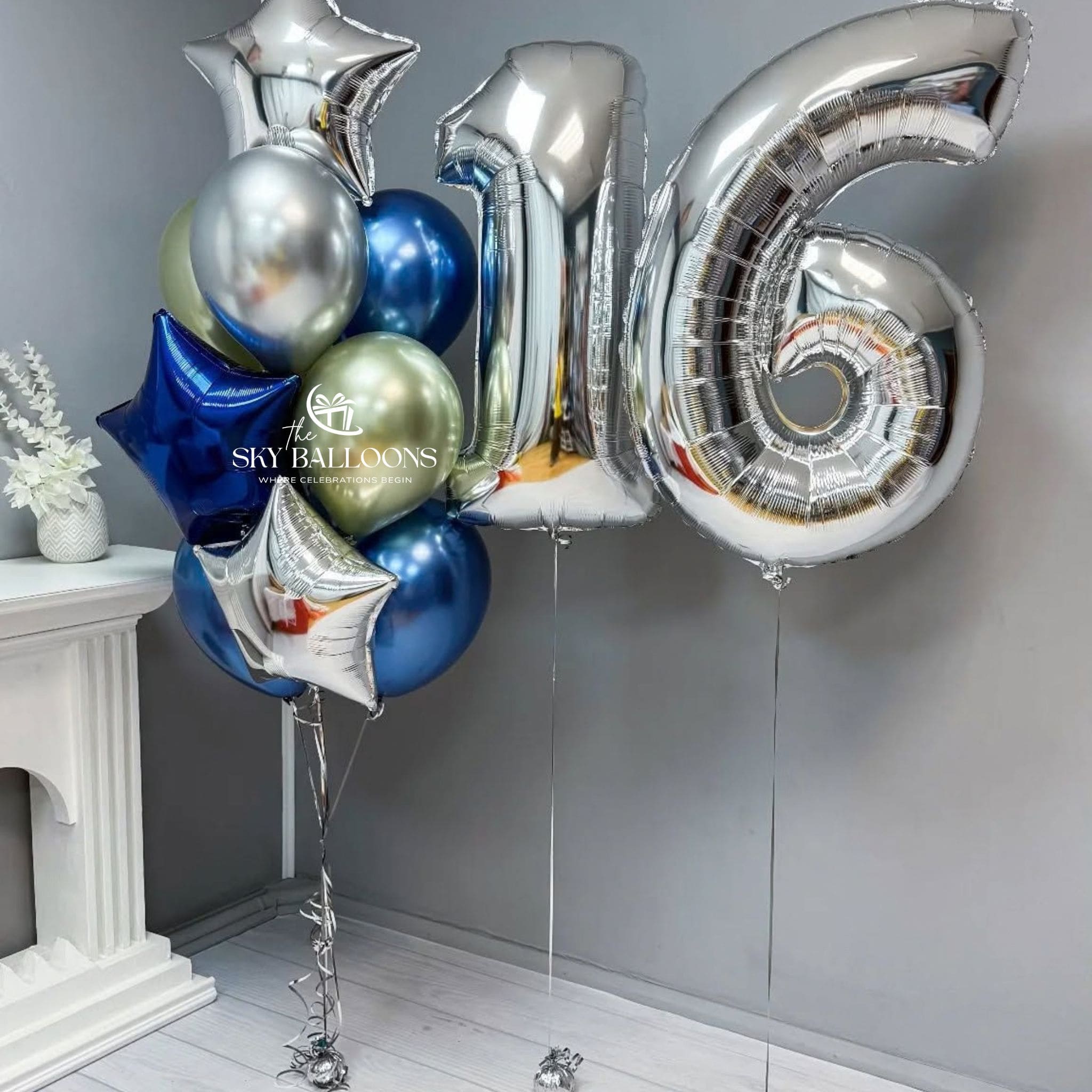 Silver number 16 foil balloons beside a bouquet of blue and silver stars with metallic navy blue, silver and pale gold latex balloons.