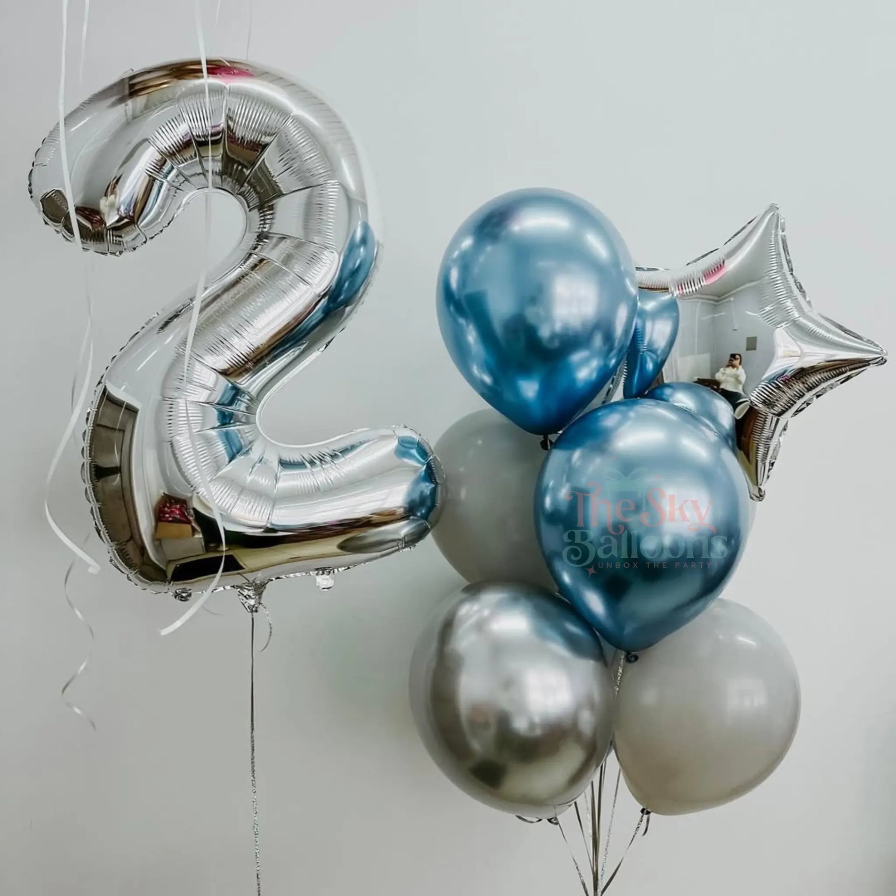 Silver number 2 balloon, blue and silver balloons with 'The Star Balloon Co.' branding on a light gray background.