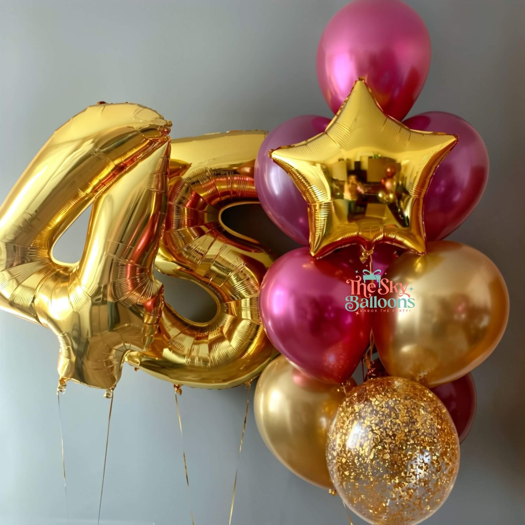 Gold and pink balloons with a number 45 and star shape, featuring 'The Star Balloons' brand.