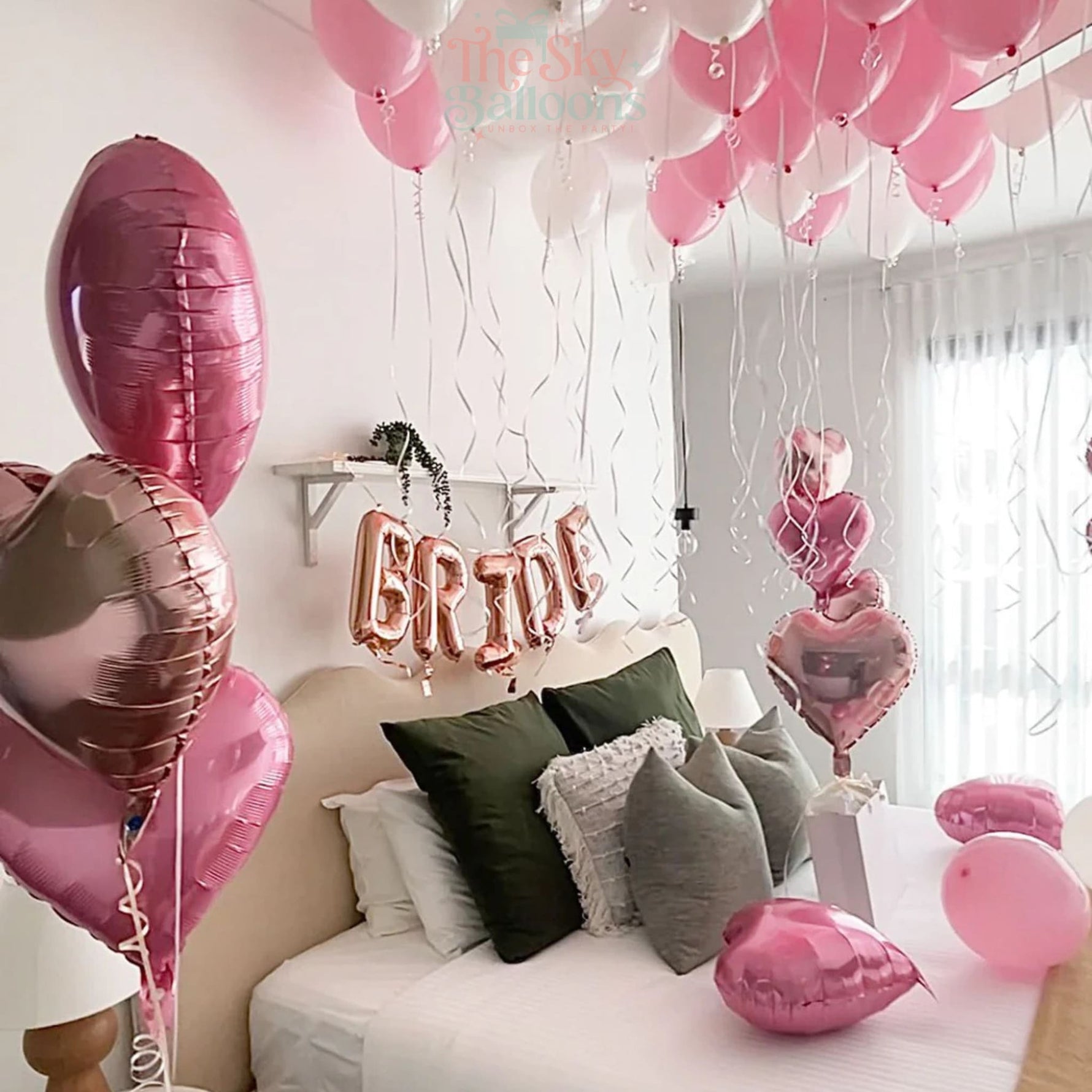 Decorated room with balloons and 'Bride' sign, likely for a wedding celebration.