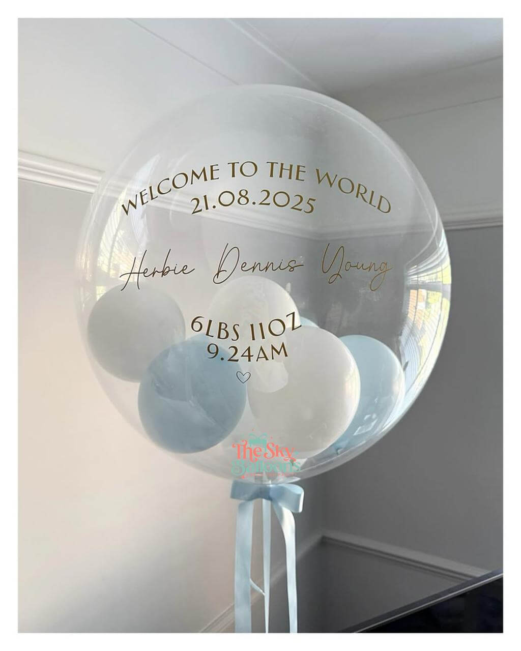 Clear bubble balloon with personalized text and baby weight, date, and time details.