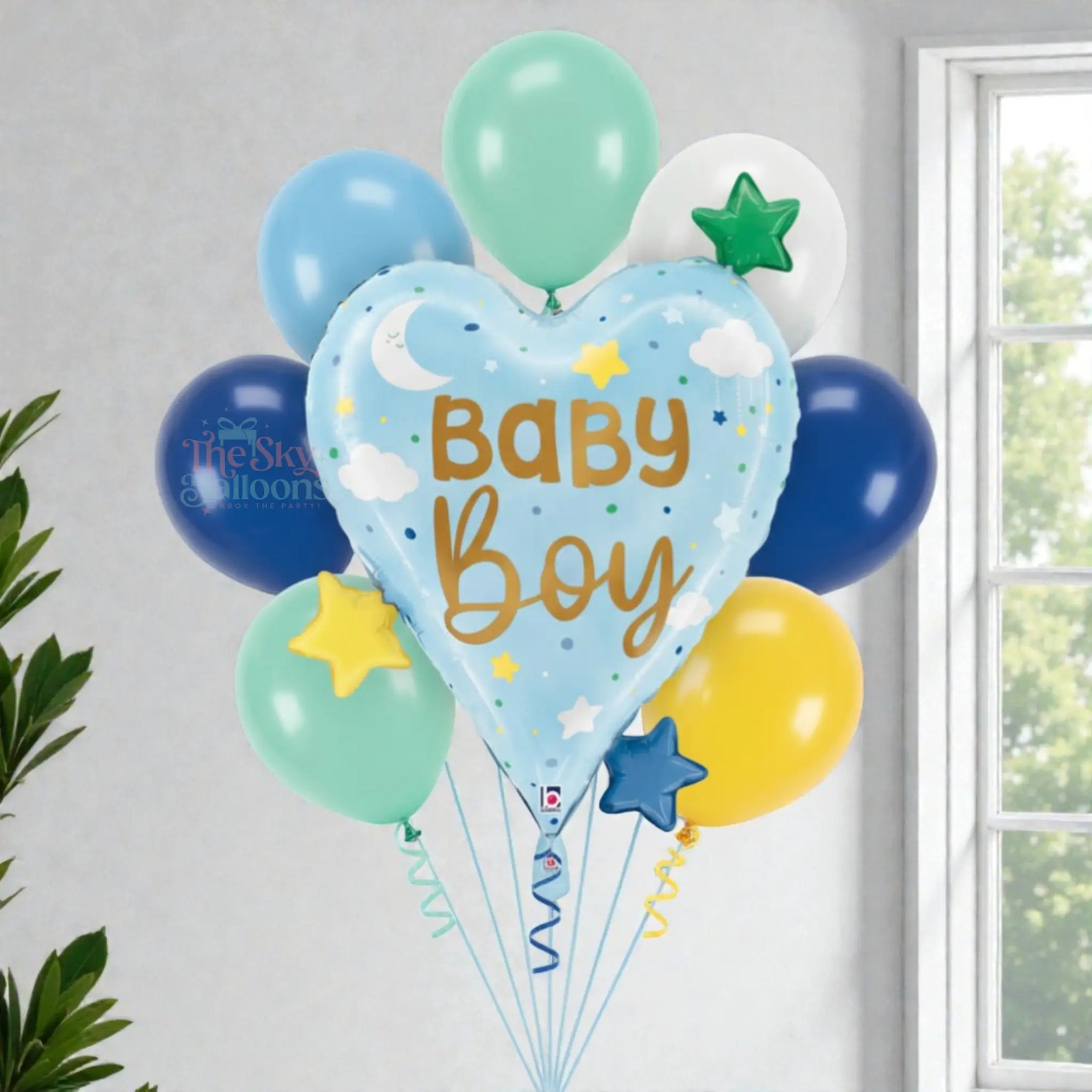 Balloon bouquet with 'Baby Boy' text against a light gray wall.