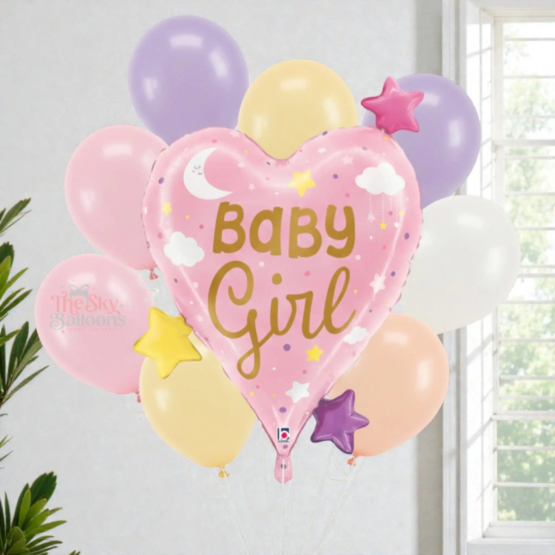 Heart-shaped balloon with 'Baby Girl' text among other colorful balloons against a light background.