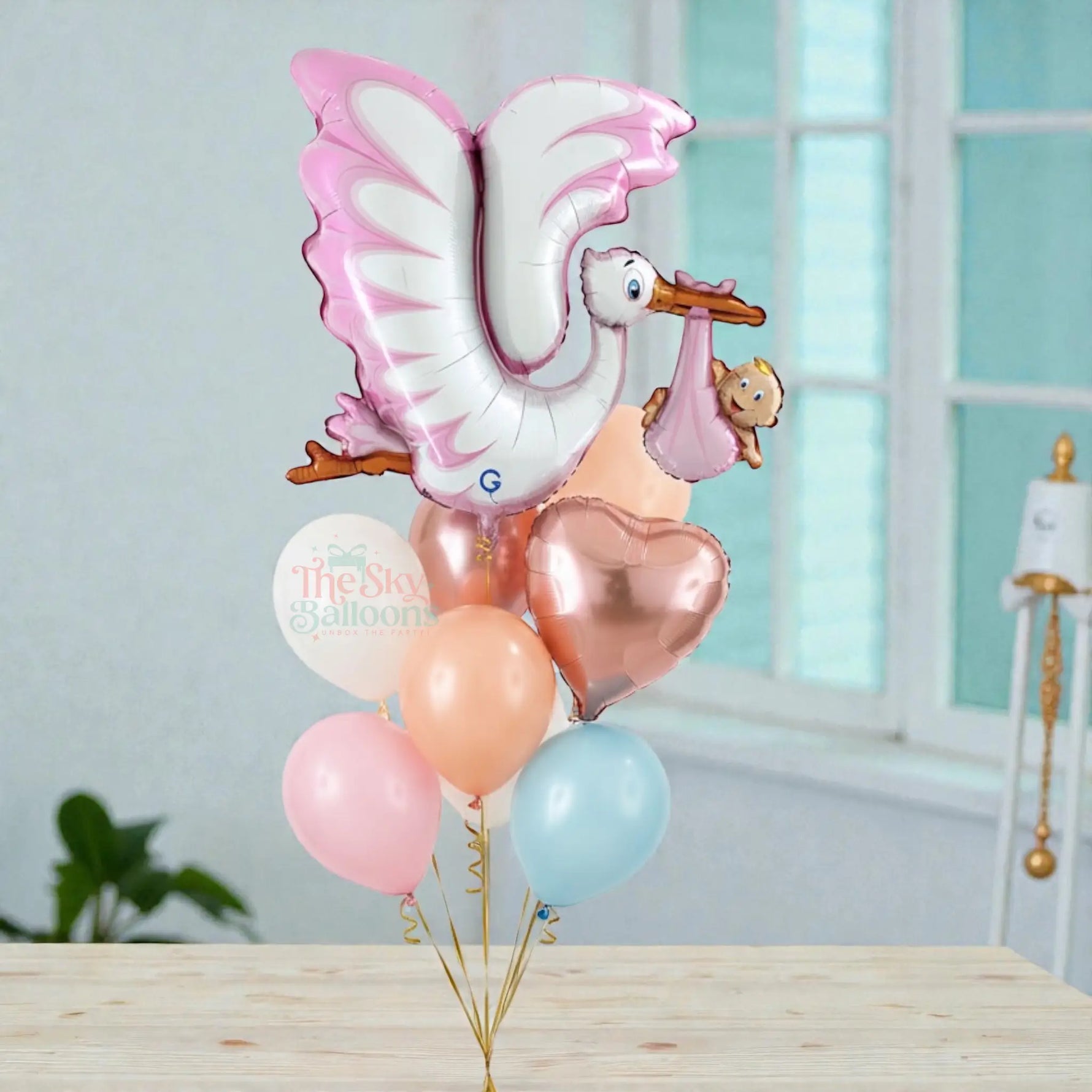 Balloon bouquet with stork and baby balloon on a white background