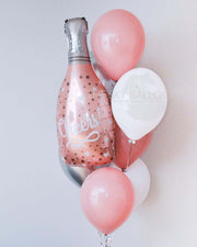  Colorful balloons arranged around a champagne bottle, perfect for celebrations and special occasions.