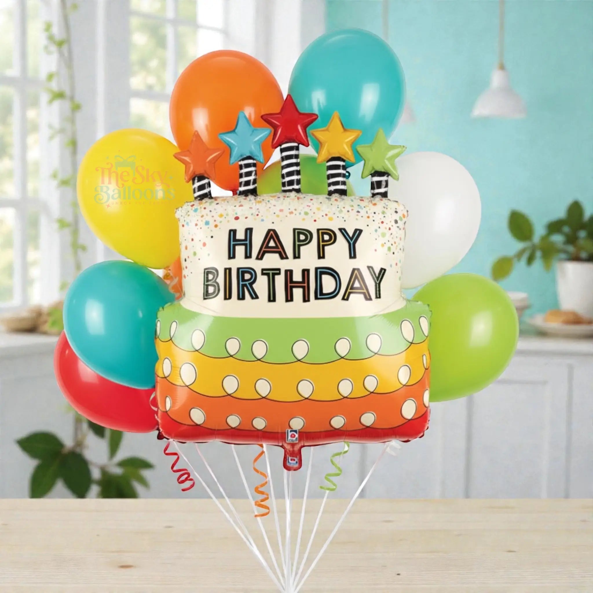 Colorful birthday balloon bouquet with a cake-shaped balloon and 'Happy Birthday' text on a white background.