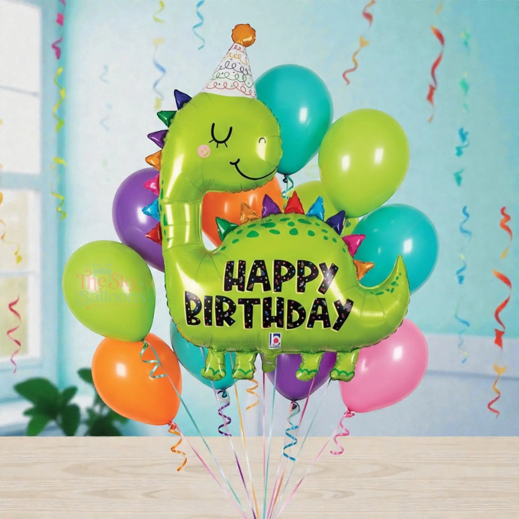 Colorful balloon bouquet with a dinosaur-shaped balloon saying 'Happy Birthday' on a white background