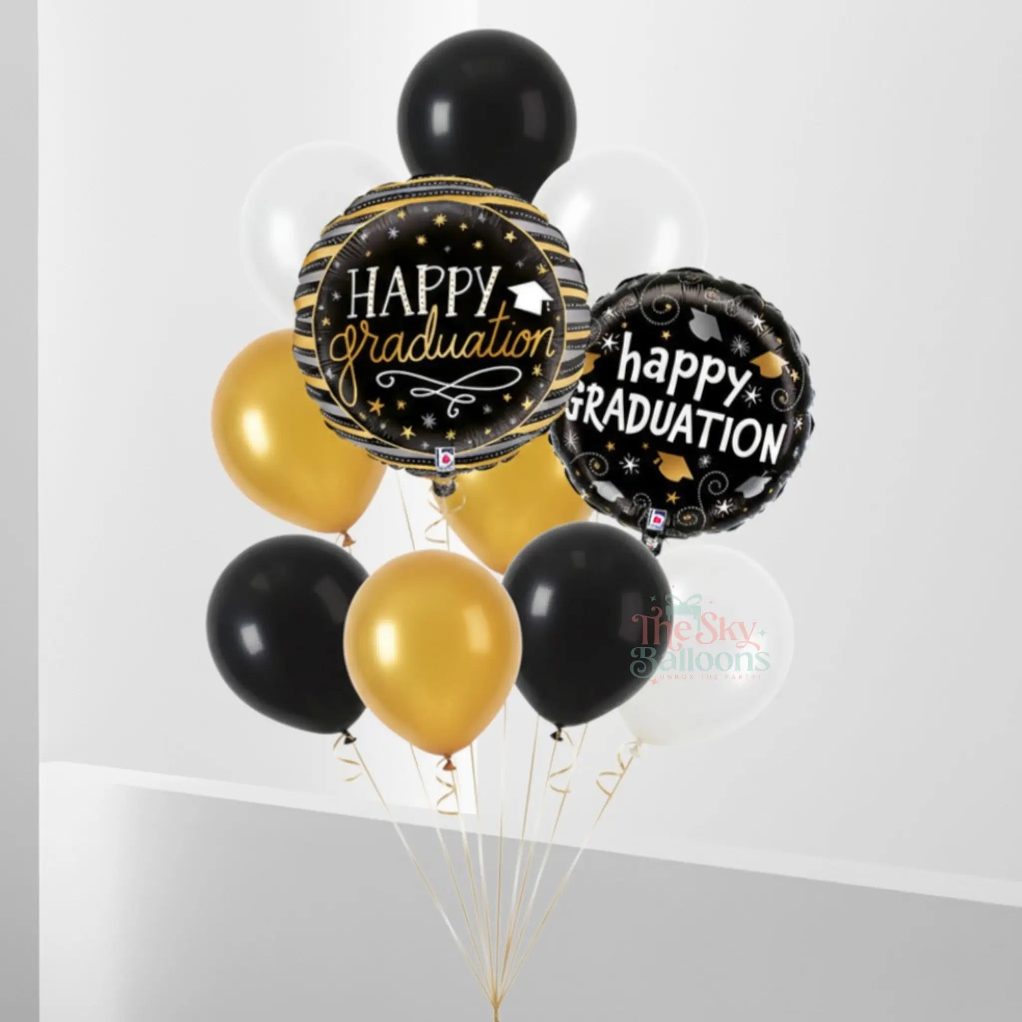 Graduation-themed balloons with 'Happy Graduation' text on a white background