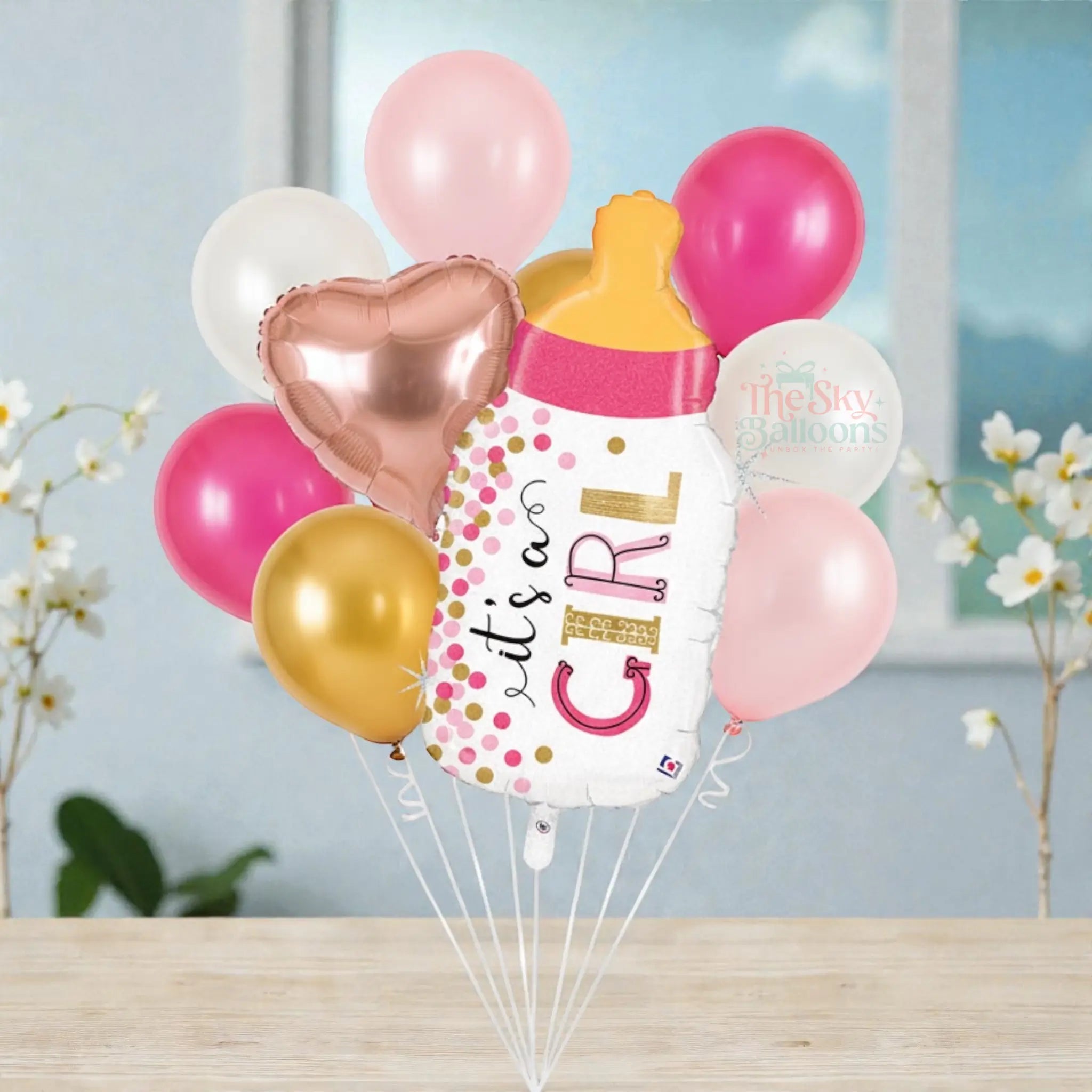 Balloon bouquet with 'It's a Girl' message on a white background