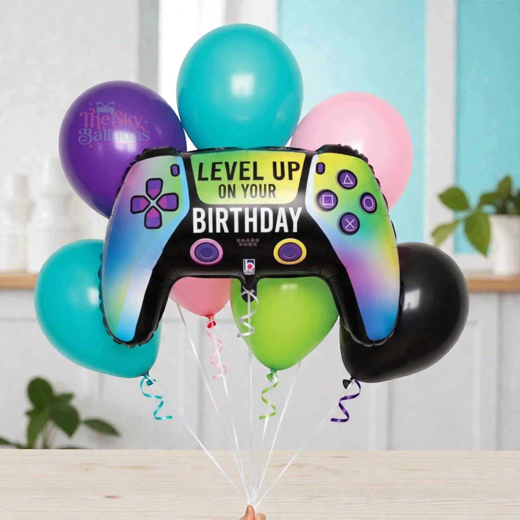 Bouquet of balloons with a game controller-shaped balloon featuring 'Level Up on Your Birthday' text.