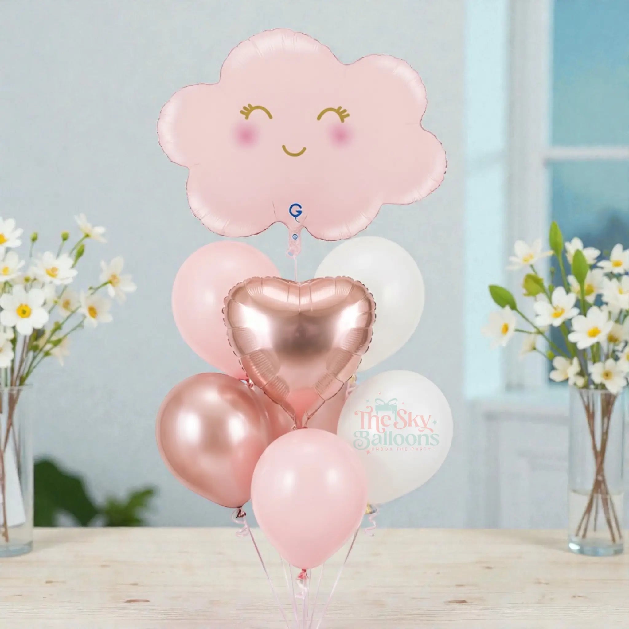 Set of balloons including a pink cloud-shaped balloon and heart-shaped balloons on a white background