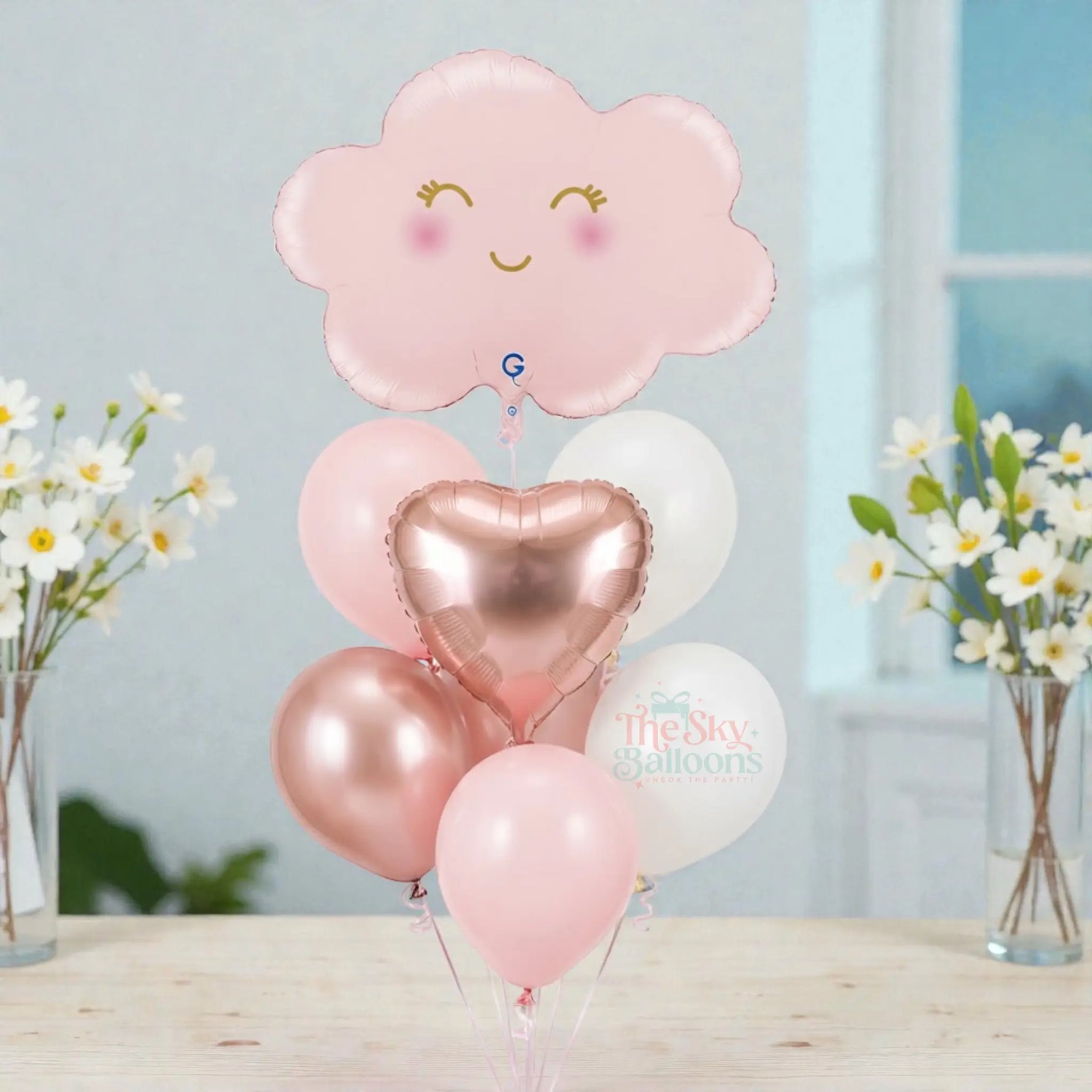 Set of balloons including a pink cloud-shaped balloon and heart-shaped balloons on a white background