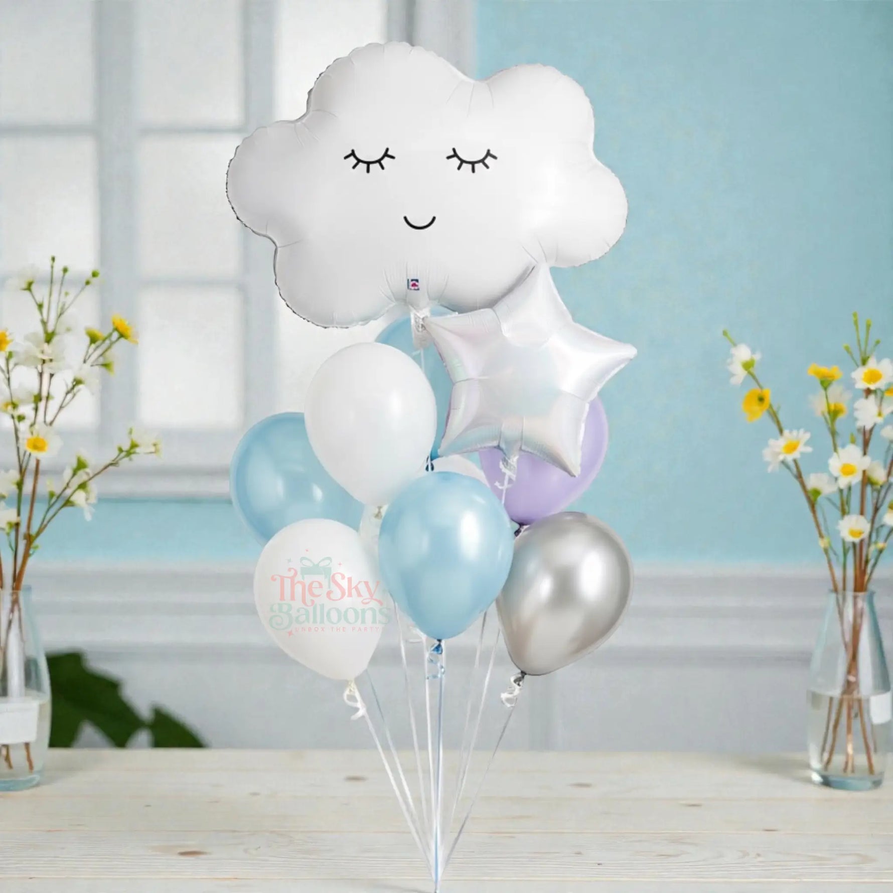 Bouquet of balloons including a cloud-shaped balloon with a smiley face on a white background