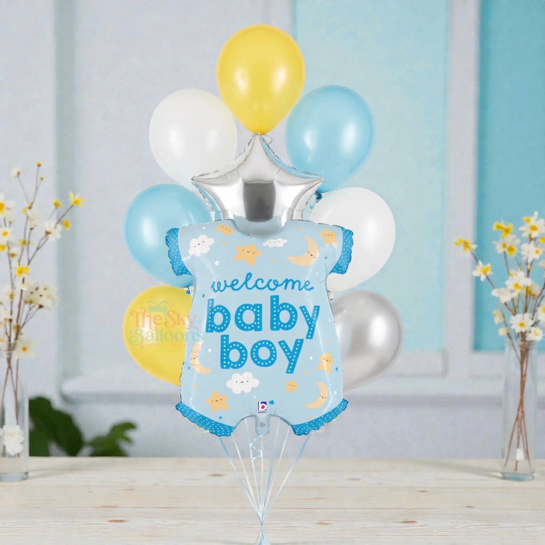 Balloon bouquet with 'welcome baby boy' message on a light blue background