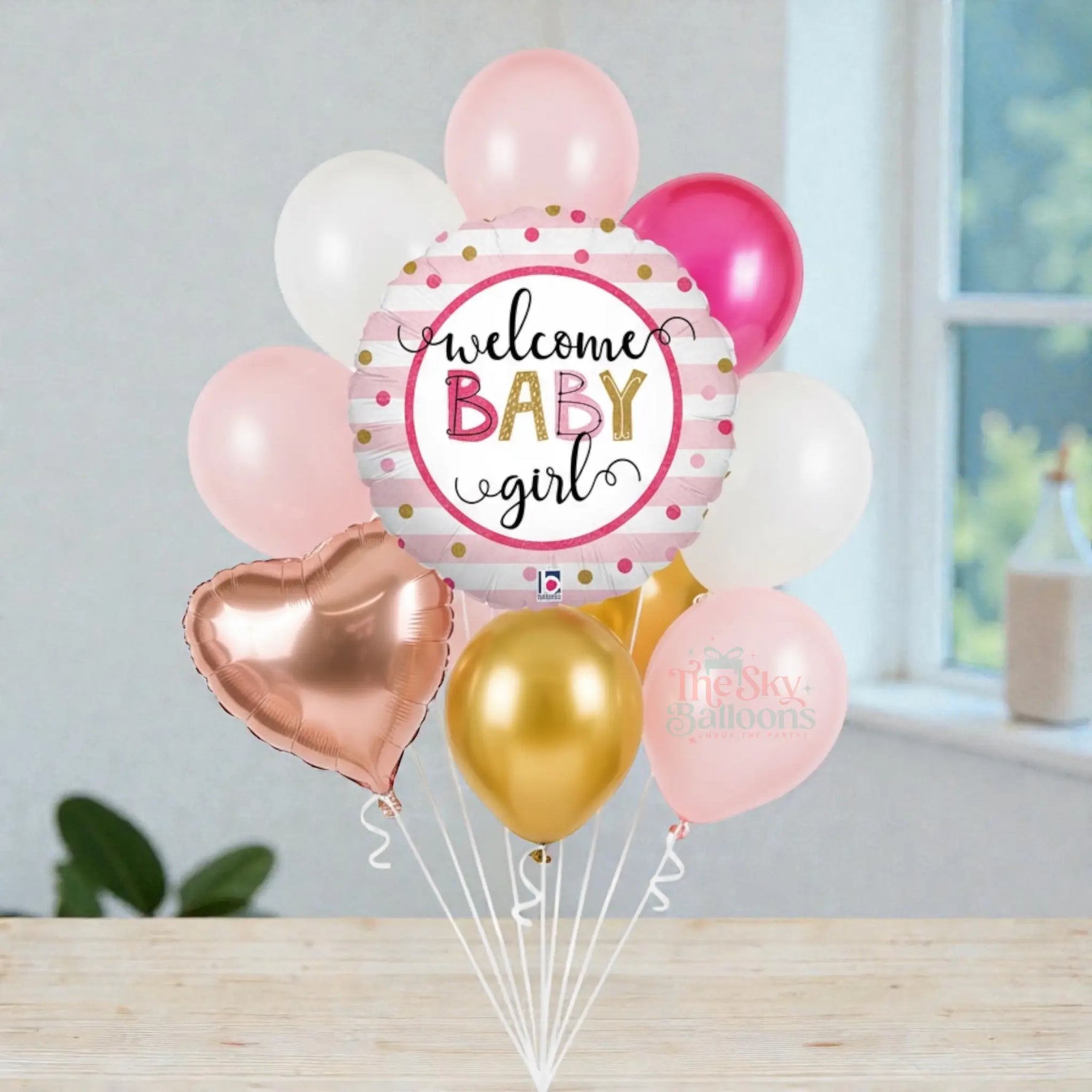 Balloon bouquet with 'Welcome Baby Girl' balloon and other colorful balloons on a white background