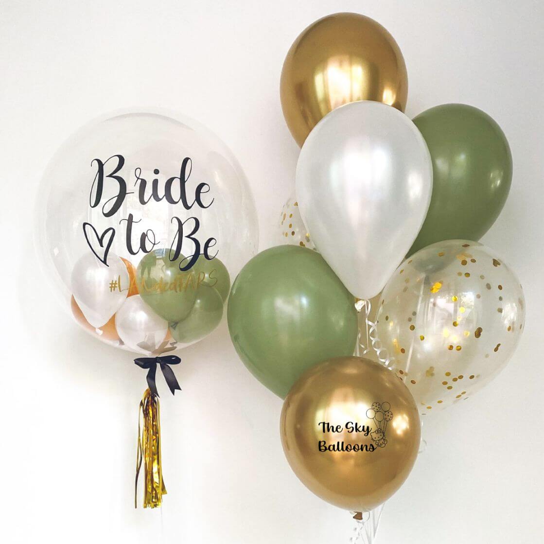Bride-to-be balloon surrounded by gold and green balloons